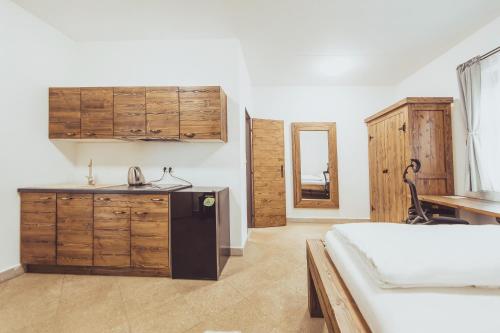 a bedroom with a bed and a sink and a kitchen at Ranč Telč in Telč