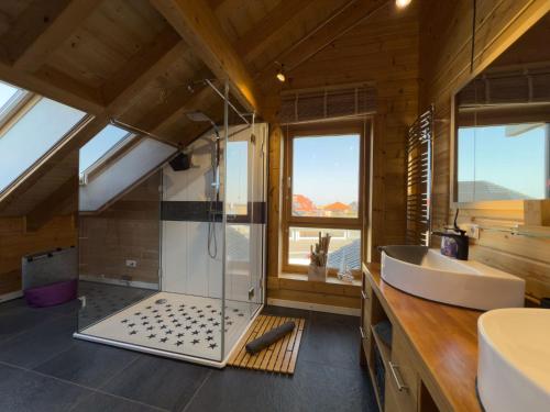 a bathroom with a tub and a sink in a room at Haus Sina in Wangerland
