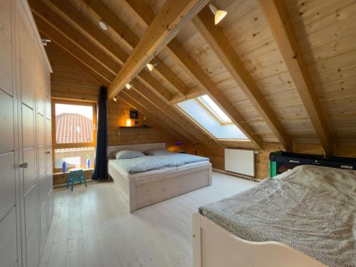 a bedroom with two beds in a wooden house at Haus Sina in Wangerland