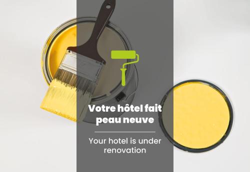 a paint brush and a pot of yellow paint at B&B HOTEL Reims Centre Erlon in Reims