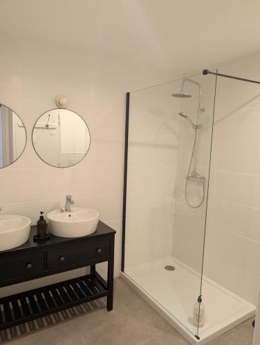 a bathroom with a glass shower and a sink at Maison Mazille in Mazille