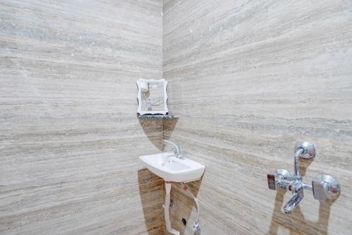 a bathroom with a sink and a mirror at FabHotel HR Residency in New Delhi