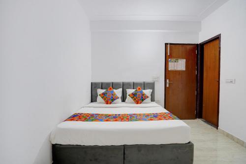 a bedroom with a large bed in a room at FabHotel HR Residency in New Delhi