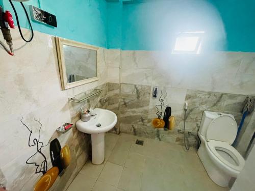 a bathroom with a toilet and a sink at Green views in Norton Bridge