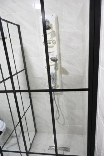 a shower in a bathroom with a glass door at Oasis in Edineţ