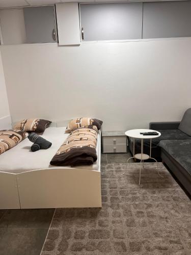 a room with a bed and a couch and a table at Centrum Apartman LEYLA 8 in Bardejov