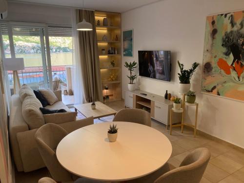 a living room with a table and a couch at Kotor Bay View Residence with Pool in Muo