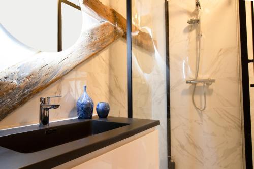 a bathroom with a black sink and a shower at Huize de Lekpoort - The Stork Loft - Loft Apartment in Vianen Center in Vianen