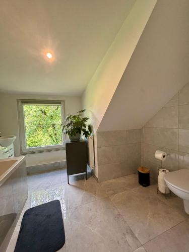 a bathroom with a sink and a toilet and a window at Willa Pod Dębem in Koczarki