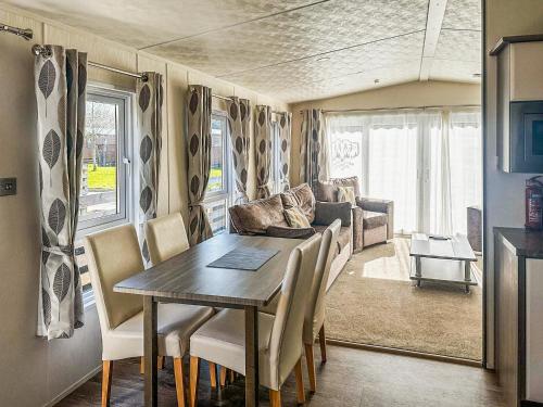 a dining room with a table and a couch at Toucana - Uk49468 in Morpeth