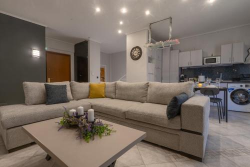a living room with a couch and a table at Elissavet Maison in Perea