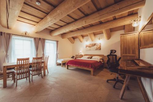 a bedroom with a bed and a table and chairs at Ranč Telč in Telč