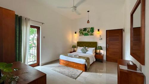 a bedroom with a bed and a large window at Blue Bird Hotels in Negombo