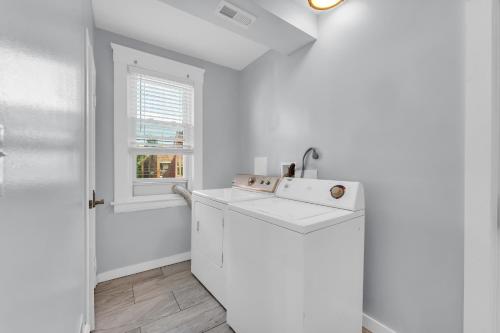 a white kitchen with a sink and a window at Stay with Jay - Quarta Suite in Cleveland