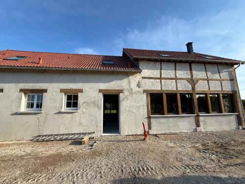a house being built with a lot of windows at La Grange aux Etangs - Les Chambres d'hôtes in Sennely