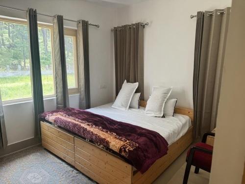 a bedroom with a bed with a large window at Samoon Guest House in Karnāl