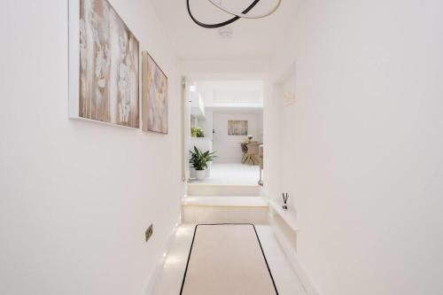 a hallway with white walls and white floors and a ceiling at Beeches Retreat in Shrewsbury