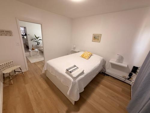a white bedroom with a bed with a tray on it at Spacious 2BR Getaway Easy Access to NYC & Newark in Kearny