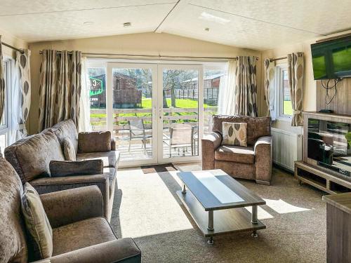 a living room with two couches and a table at Aquila - Uk49467 in Morpeth