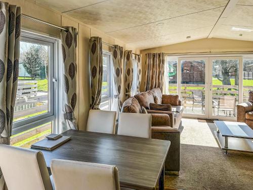 a living room with a table and chairs at Aquila - Uk49467 in Morpeth