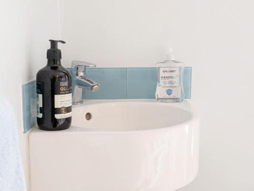a bathroom sink with a bottle of soap next to it at 2 Seafield Terrace, Bognor Regis in Bognor Regis