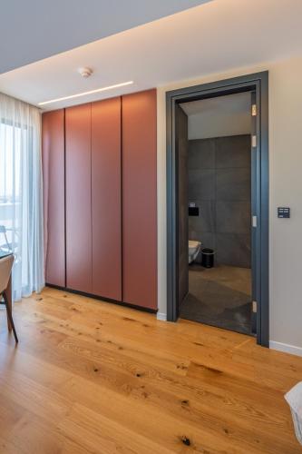 a living room with sliding doors and wood floors at Sky Suites Nicosia in Strovolos