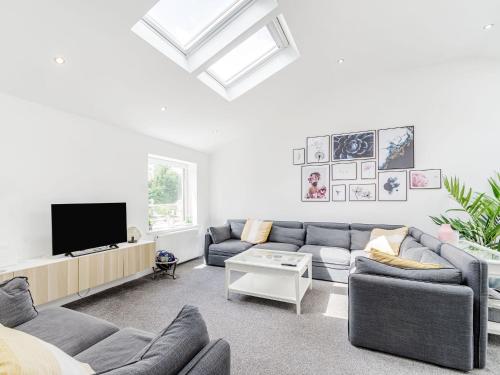 a living room with a couch and a tv at High Trees View in Knaresborough