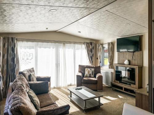 a living room with a couch and a table at Phoenix - Uk49470 in Morpeth