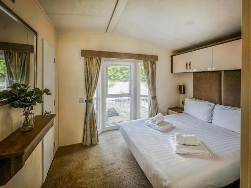 a bedroom with a large bed with towels on it at Phoenix - Uk49470 in Morpeth