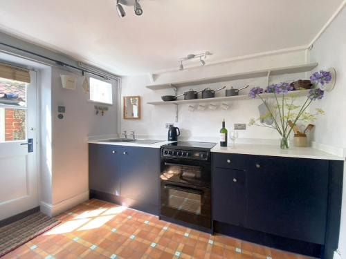 a kitchen with a stove and a counter top at Sea Breeze in Blakeney