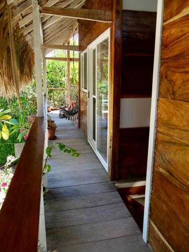 a porch of a house with a wooden floor at Santa Lova Eco-hostel Isla Tintipan in Tintipan Island