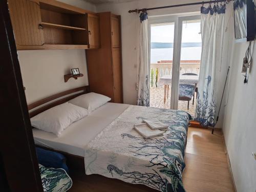 a bedroom with a bed with a view of the ocean at CHEAPEST APARTMENTS WITH PANORAMIC SEA VIEW CLOSE SANDY BEACH CRIKVENICA about 150m to sea in Crikvenica