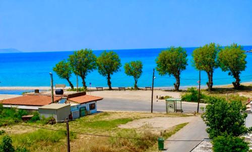 a view of a beach with trees and the ocean at Pearl Seaside Cozy Apartments in Chania