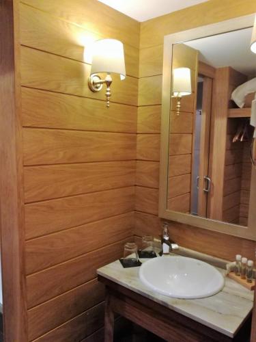 a bathroom with a sink and a mirror at Hotel Cuéntame La Puebla in Burgos