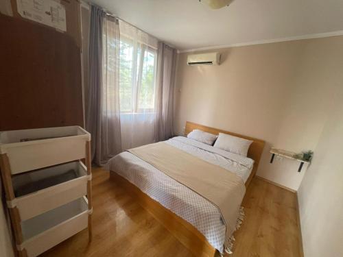 a small bedroom with a bed and a window at Sirena condo 50 m from the central beach in Byala