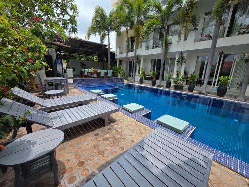 a swimming pool with chaise lounge chairs next to a building at Angkor Sweet Night Hotel in Siem Reap