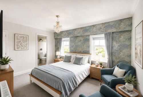 a bedroom with a bed and a couch and a chair at The Fossil Tree Hotel in Blackpool