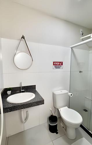 a white bathroom with a sink and a toilet at Studio #3 Rubi in Campos dos Goytacazes