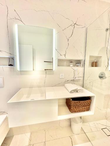 a white bathroom with a sink and a mirror at Villa Loka-Ecrin contemporain Adult only in Sauzet