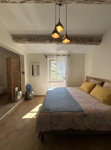 a bedroom with a bed and a window at Au Clair Ventoux in Saint-Didier