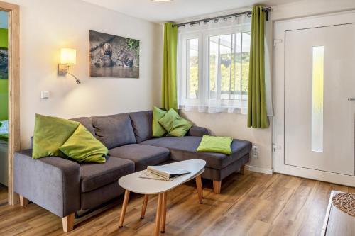 a living room with a couch and a table at Ferienhaus Biber im Sternenpark in Lochow
