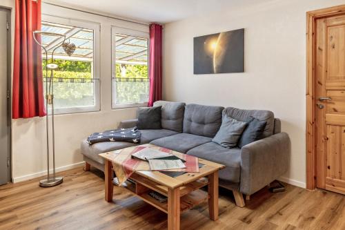 a living room with a couch and a table at Ferienhaus Jupiter im Sternenpark in Lochow
