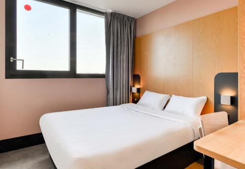 a hotel room with a bed and a window at B&B HOTEL Montpellier Centre Le Millénaire 3 étoiles in Montpellier