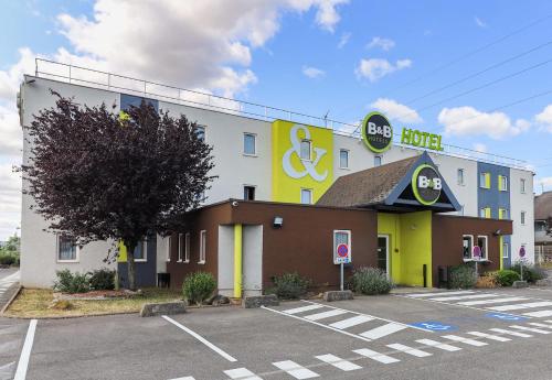 a hotel with a sign on the side of a building at B&B HOTEL Dijon Les Portes du Sud in Marsannay-la-Côte