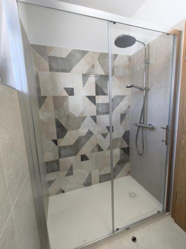 a shower with a glass door in a bathroom at Apartman Maledi in Baška
