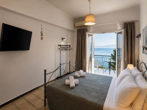 a bedroom with a bed with a view of the ocean at Novus seaview in Benitses