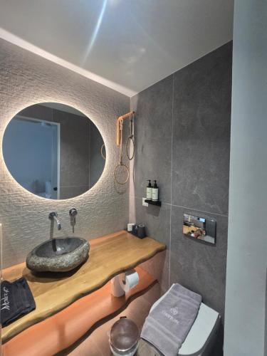 a bathroom with a sink and a mirror at Olvion Luxury Living in Kallithea Halkidikis