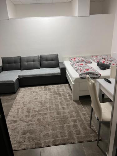 a room with two beds and a couch and a table at Centrum Apartman LEYLA 7 in Bardejov