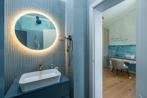 a bathroom with a sink and a mirror at Villa Da Ella by IstriaLux in Krnica