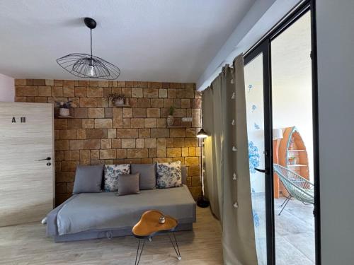 a bedroom with a bed and a brick wall at Apartments Panda in Bol